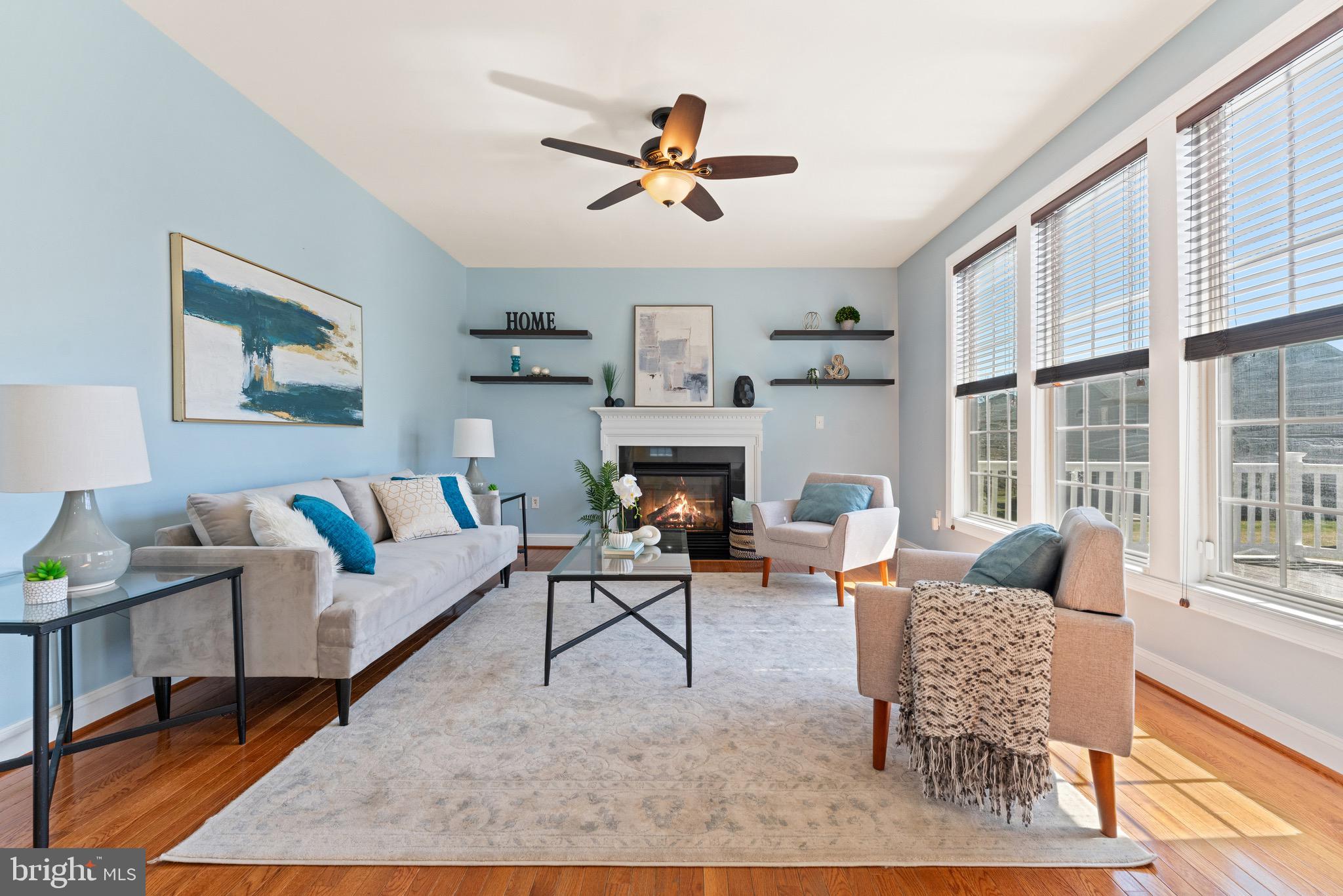 16277 Jetty Loop Woodbridge, VA 22191 - Photo 15 of 92 a living room with furniture a fireplace and a table