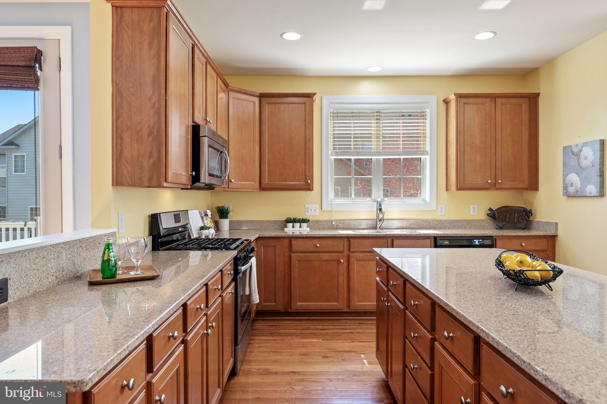 16277 Jetty Loop Woodbridge, VA 22191 - Photo 18 of 92 a kitchen with stainless steel appliances granite countertop a sink stove and cabinets