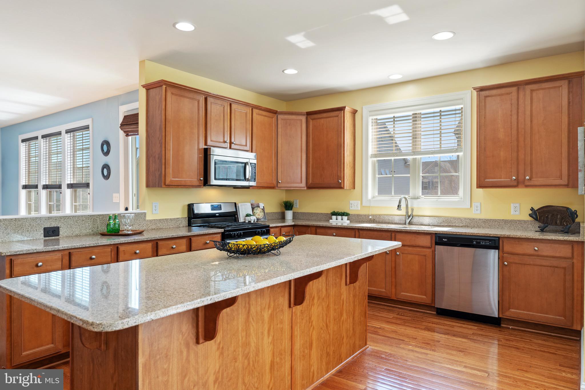 16277 Jetty Loop Woodbridge, VA 22191 - Photo 23 of 92 a kitchen with stainless steel appliances granite countertop a sink stove and cabinets