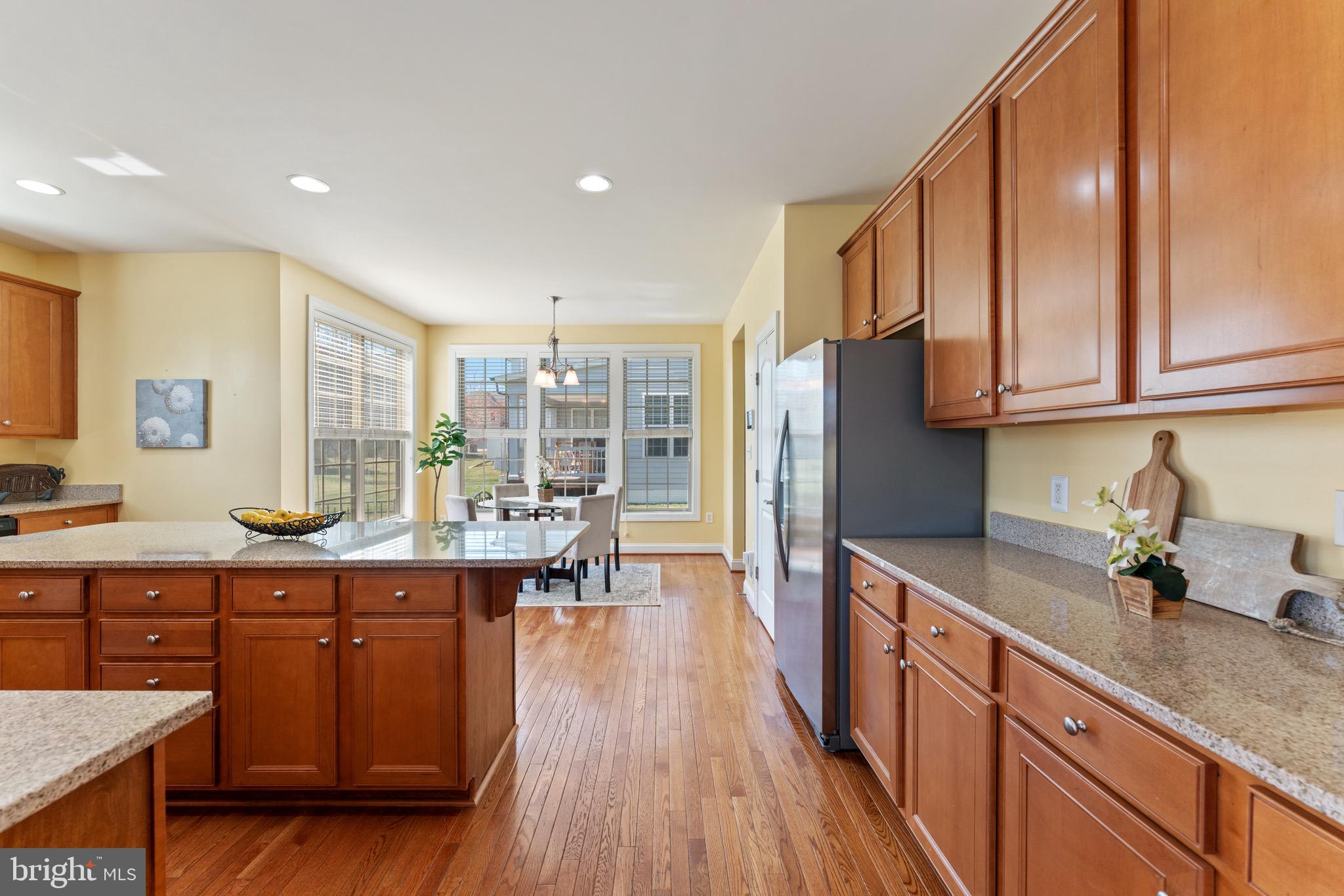 16277 Jetty Loop Woodbridge, VA 22191 - Photo 24 of 92 a kitchen with stainless steel appliances granite countertop a refrigerator a sink dishwasher a stove and white countertops with wooden floor