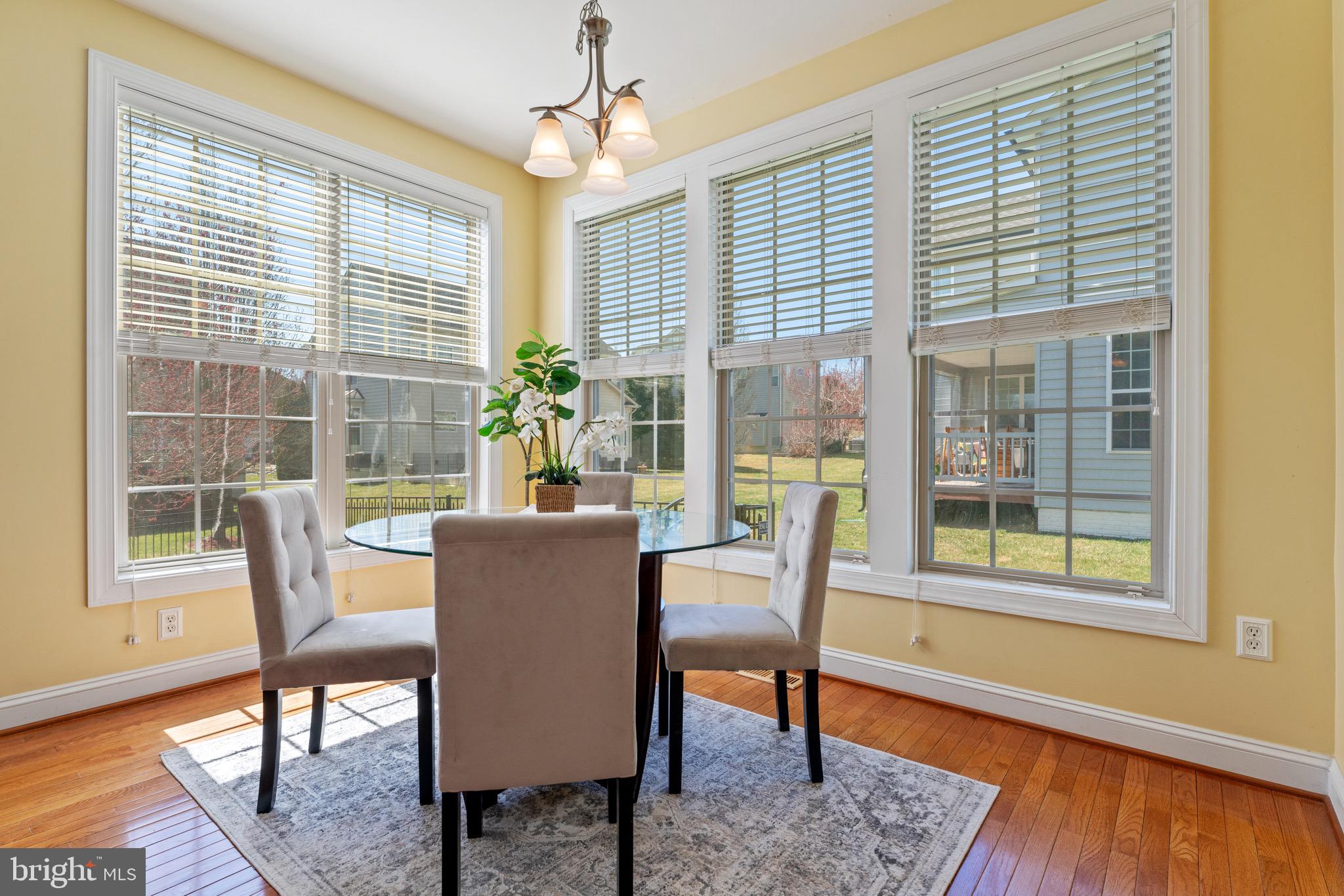 16277 Jetty Loop Woodbridge, VA 22191 - Photo 26 of 92 a dining room with furniture windows and wooden floor