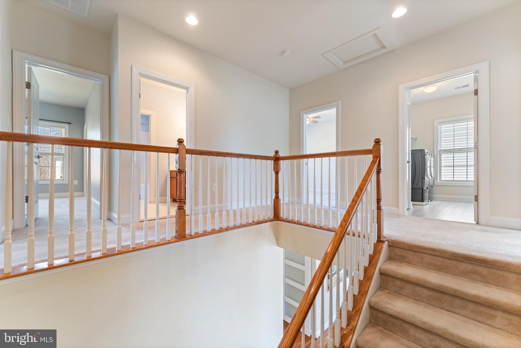 16277 Jetty Loop Woodbridge, VA 22191 - Photo 42 of 92 a view of staircase with lots of frames on wall and a large window