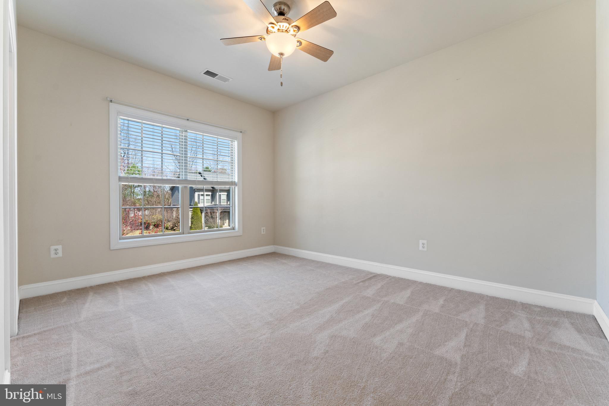 16277 Jetty Loop Woodbridge, VA 22191 - Photo 50 of 92 an empty room with windows and chandelier fan