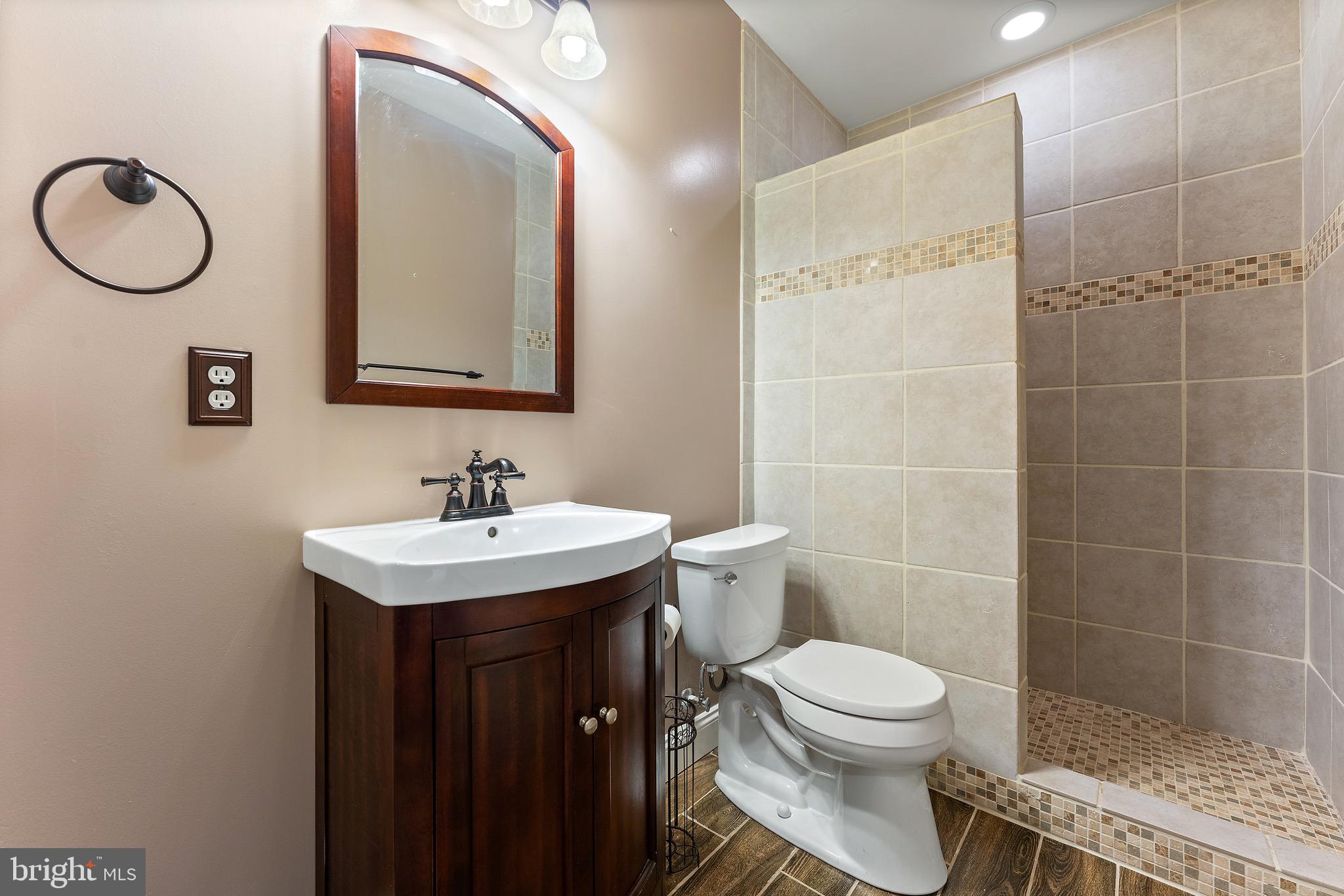 16277 Jetty Loop Woodbridge, VA 22191 - Photo 68 of 92 a bathroom with a toilet sink vanity and mirror