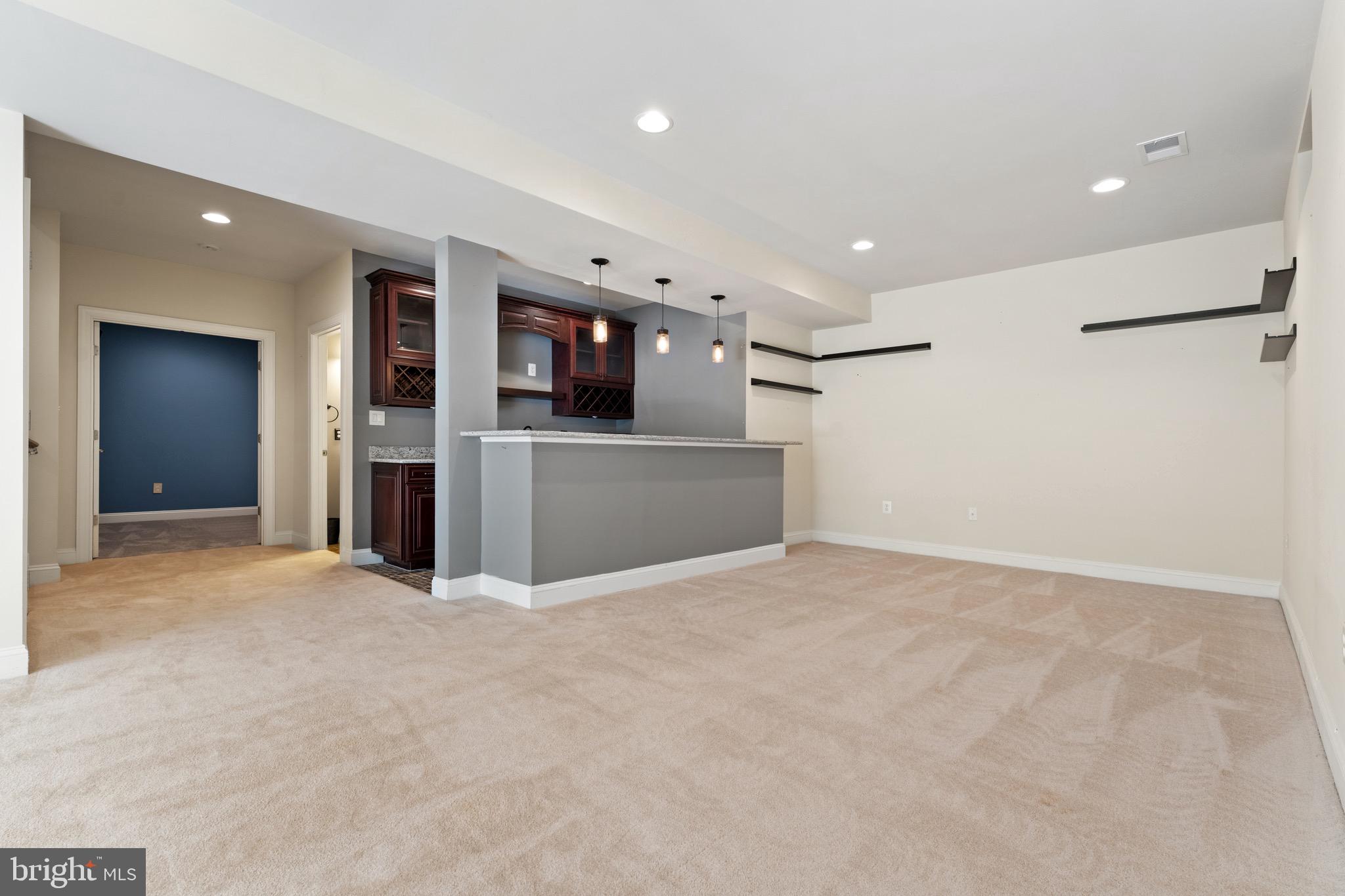 16277 Jetty Loop Woodbridge, VA 22191 - Photo 77 of 92 a view of an empty room with a refrigerator