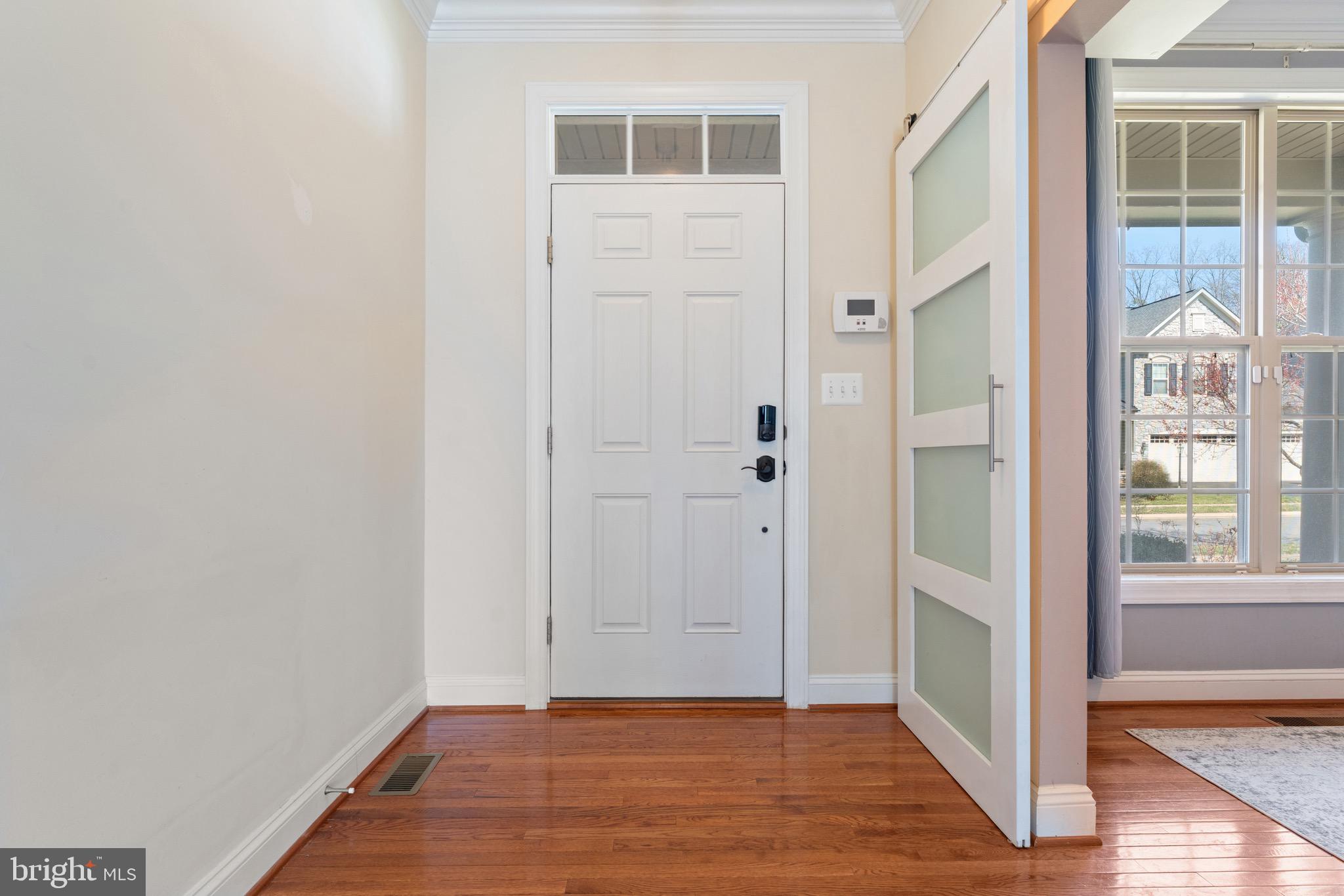 16277 Jetty Loop Woodbridge, VA 22191 - Photo 9 of 92 an empty room with wooden floor and windows