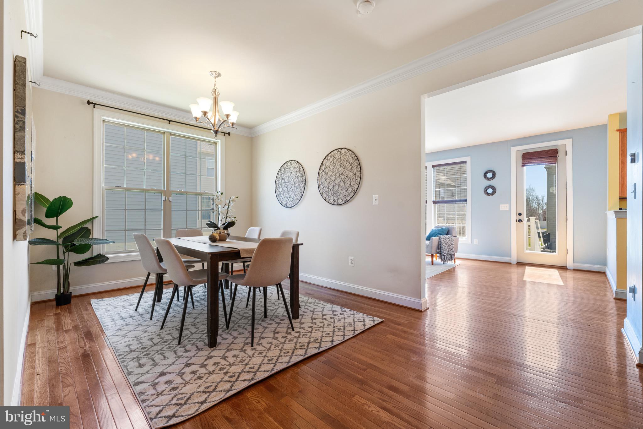 16277 Jetty Loop Woodbridge, VA 22191 - Photo 10 of 92 a view of a dining room with furniture and wooden floor