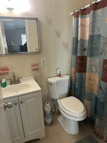 a white toilet sitting next to a bathroom sink