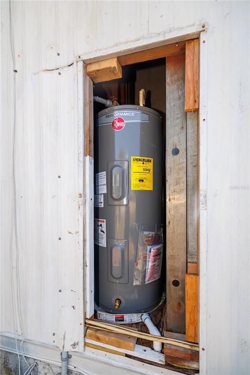 412 Osprey Drive Sebastian, FL 32976 - Photo 26 of 35 a room with water heater and a cabinet door