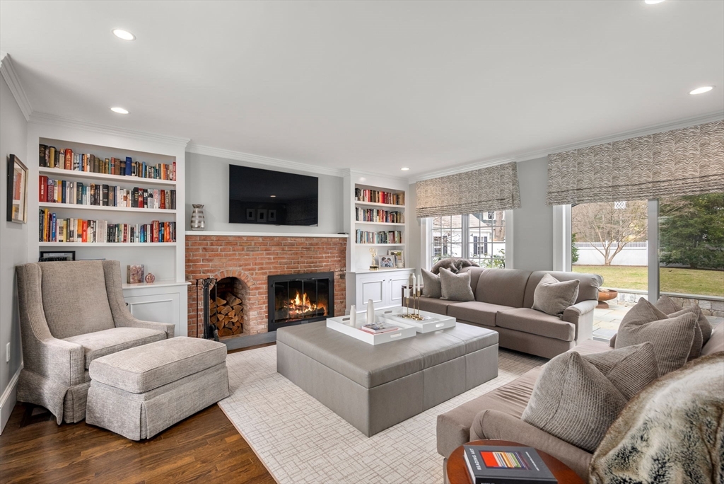 11 Mossfield Road Newton, MA 02468 - Photo 8 of 32 a living room with furniture a flat screen tv and a fireplace