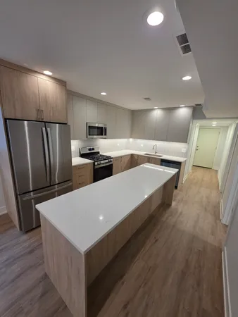 a kitchen with stainless steel appliances a refrigerator and a stove top oven