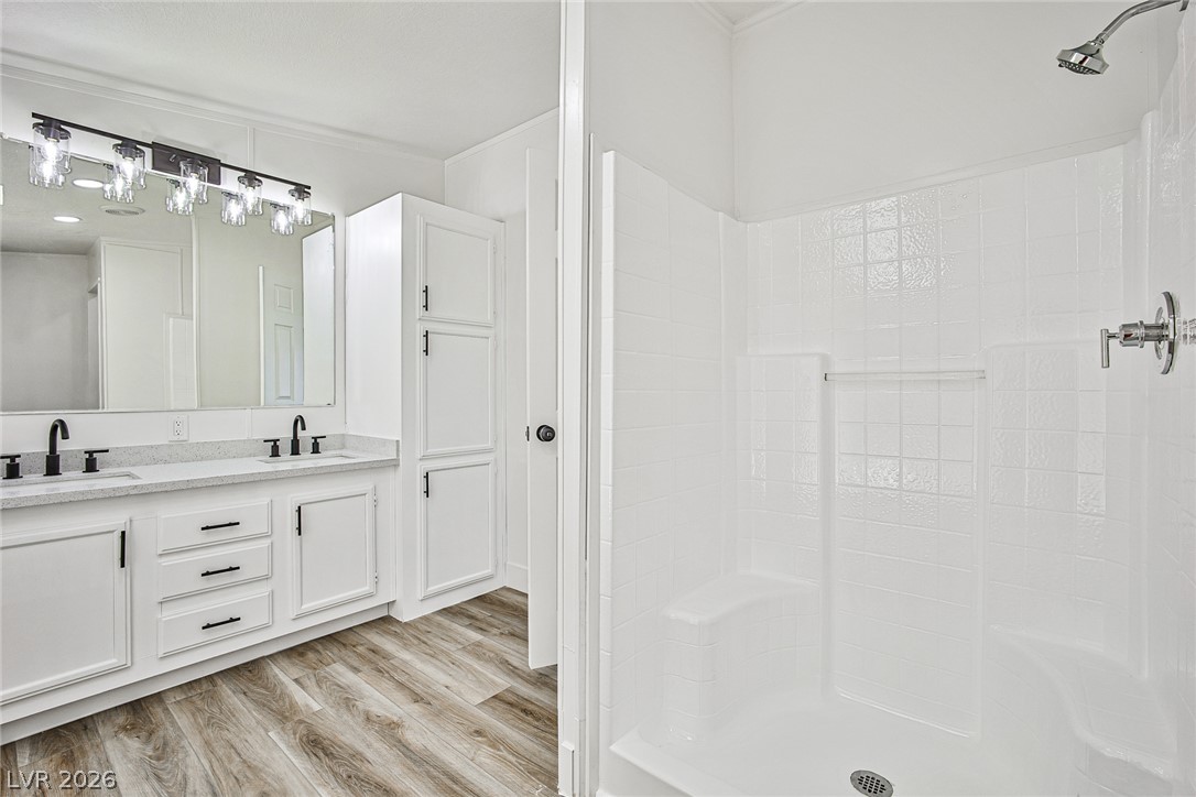 273 Aztec Lane Henderson, NV 89015 - Photo 20 of 28 Modern elegance defines this primary bath, featuring dual vanities and a pristine walk-in shower.