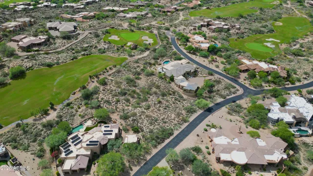 an aerial view of a house with a yard and lake view