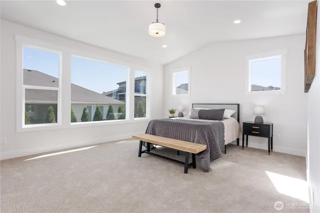 a bedroom with a large bed and a large window