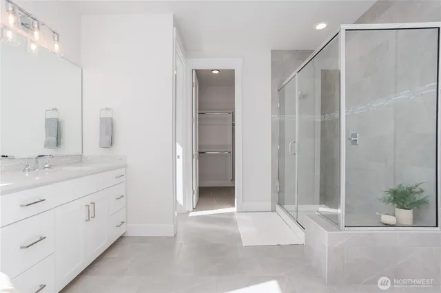 a bathroom with a shower and a bath tub
