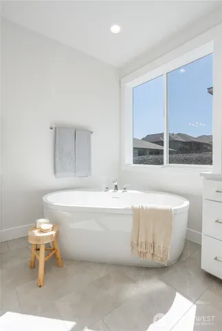 a view of a hallway with wooden floor and a workspace