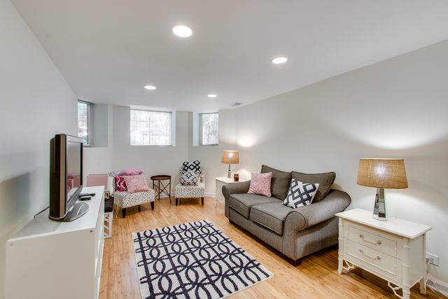 a living room with furniture a window and a flat screen tv