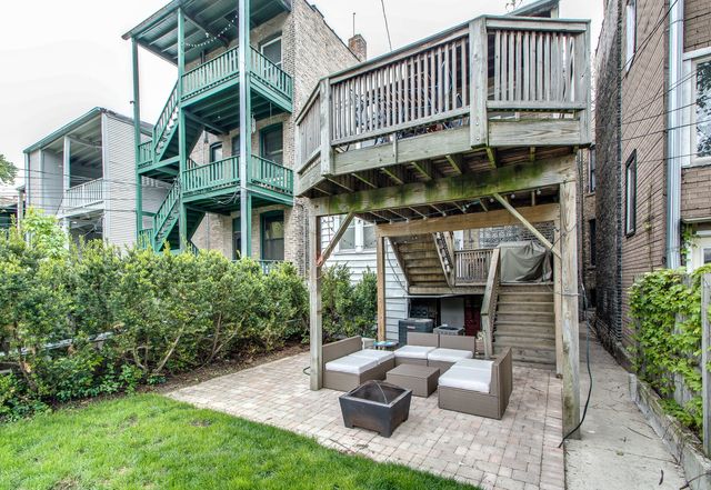 a balcony with furniture and a fireplace