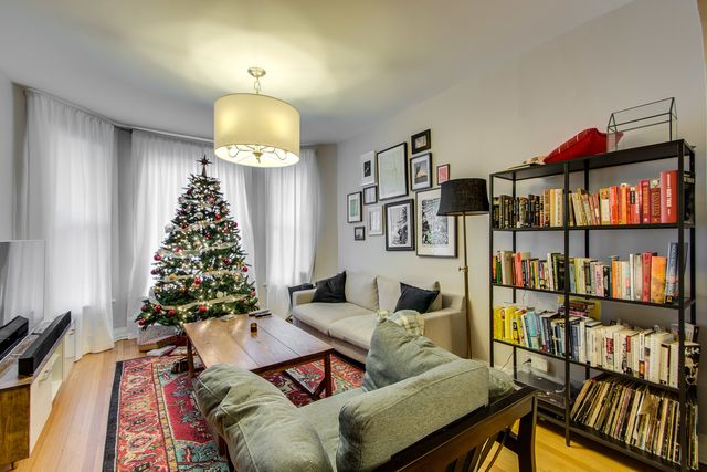 a living room with furniture a rug and a window