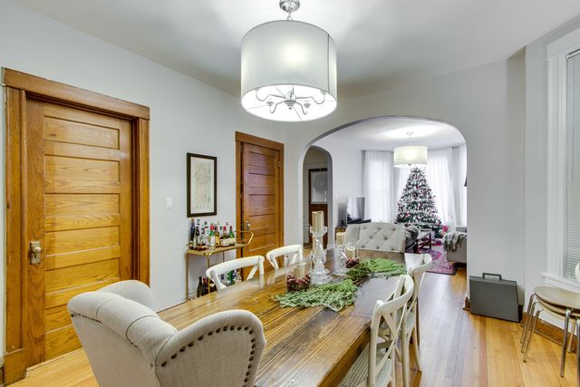 a living room with furniture chandelier and a large window
