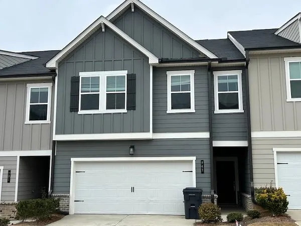 a front view of a house with many windows