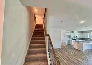 a view of a kitchen with wooden floor and electronic appliances