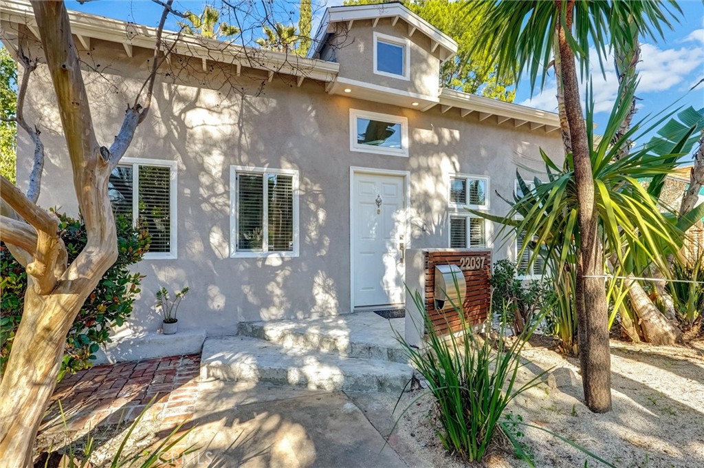 22037 Ybarra Road Woodland Hills, CA 91364 - Photo 1 of 32 a view of a potted plants in front of a house