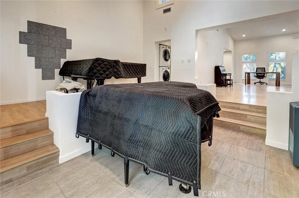 22037 Ybarra Road Woodland Hills, CA 91364 - Photo 16 of 32 a bedroom with a bed and mirror