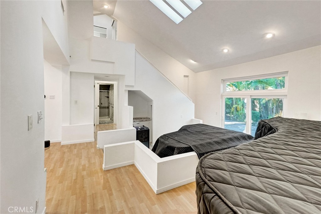 22037 Ybarra Road Woodland Hills, CA 91364 - Photo 18 of 32 a bedroom with two beds and a large window