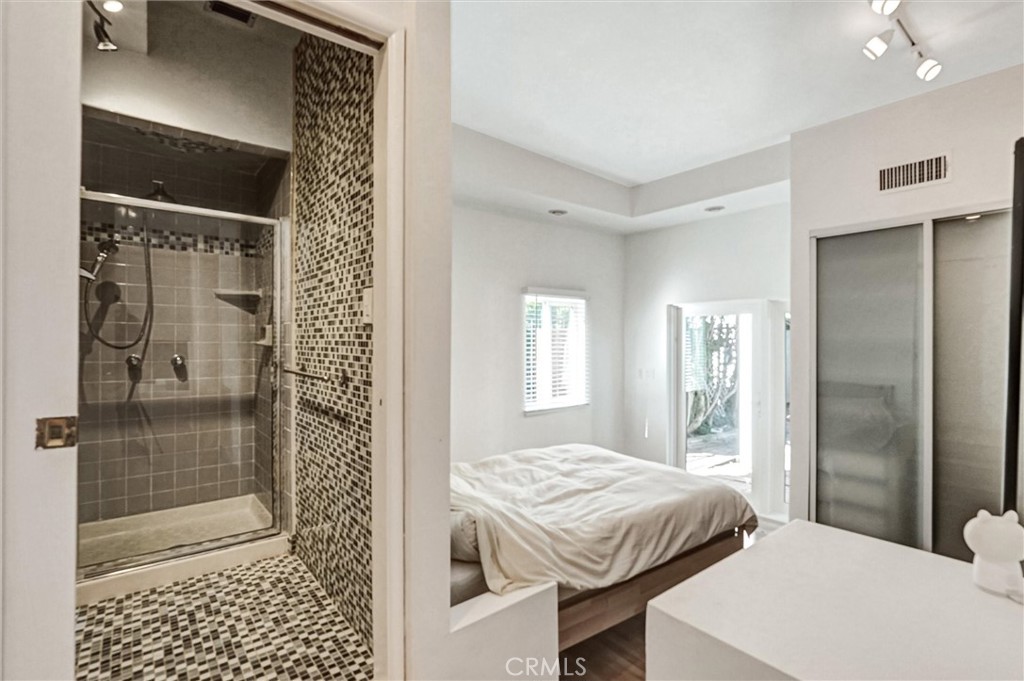 22037 Ybarra Road Woodland Hills, CA 91364 - Photo 20 of 32 a bedroom with a bed and a shower