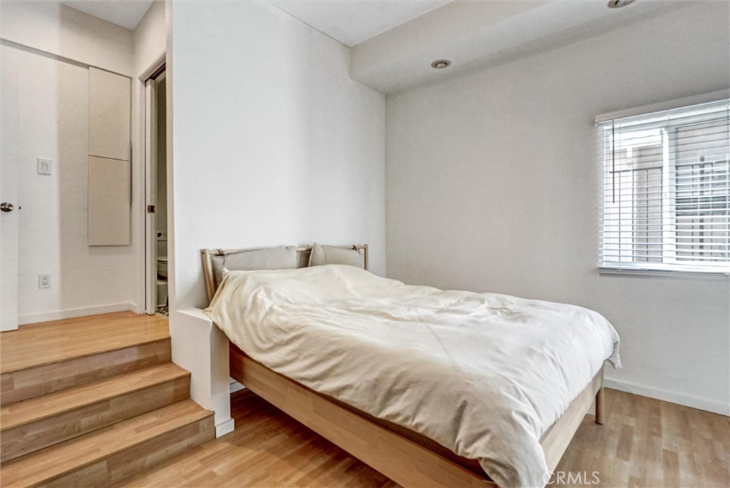 22037 Ybarra Road Woodland Hills, CA 91364 - Photo 22 of 32 a large bed sitting in a bedroom next to a window