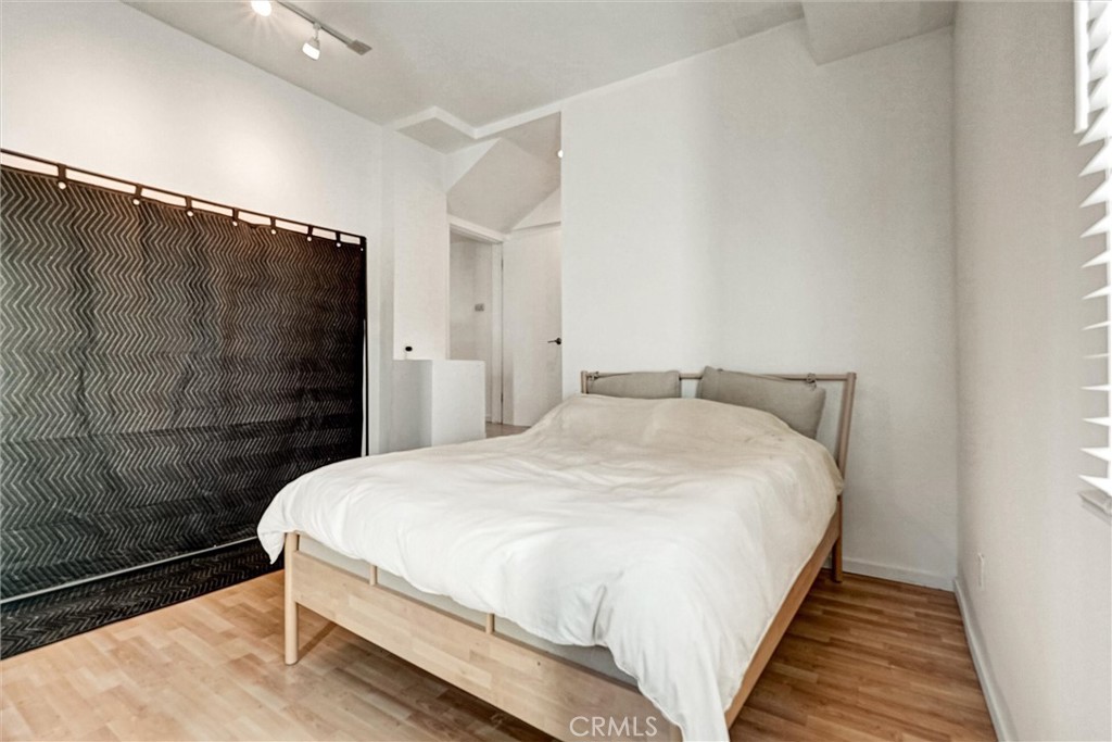 22037 Ybarra Road Woodland Hills, CA 91364 - Photo 23 of 32 a bedroom with a bed and a shower