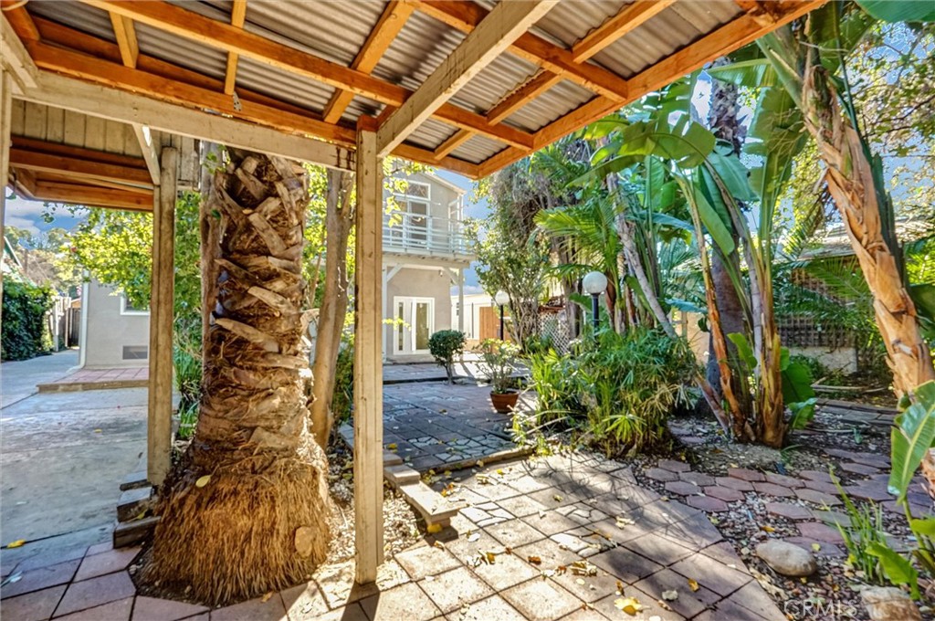 22037 Ybarra Road Woodland Hills, CA 91364 - Photo 32 of 32 a view of a porch with plants and trees