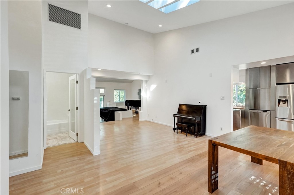 22037 Ybarra Road Woodland Hills, CA 91364 - Photo 8 of 32 a living room with furniture and a wooden floor