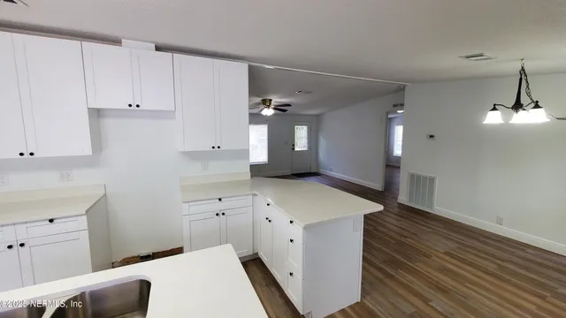 a spacious bathroom with a sink and a mirror