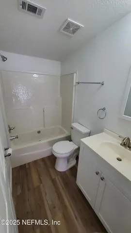 a bathroom with a sink a toilet and a tub
