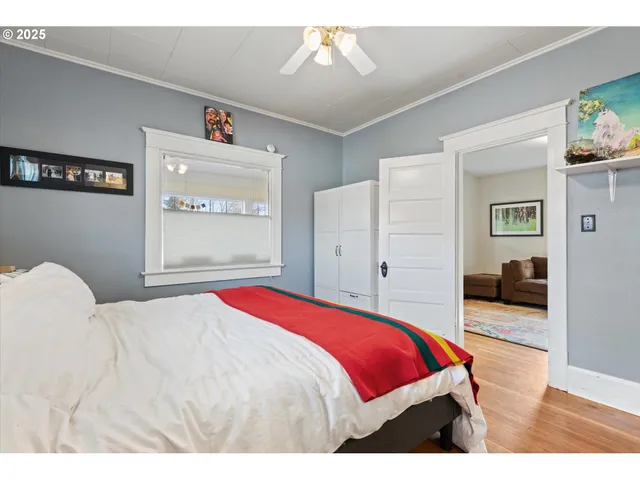 a bedroom with a bed and a view of kitchen