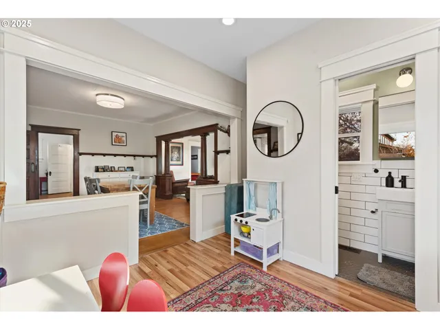 a living room with furniture a flat screen tv and a wooden floor