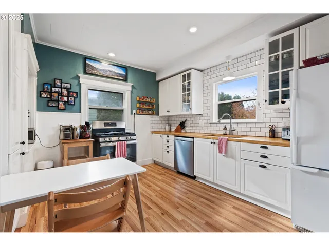 a kitchen with stainless steel appliances kitchen island granite countertop a sink counter space and cabinets