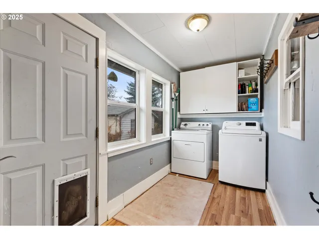 a view of washer and dryer with white walls