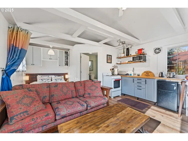 a living room with furniture and a kitchen view