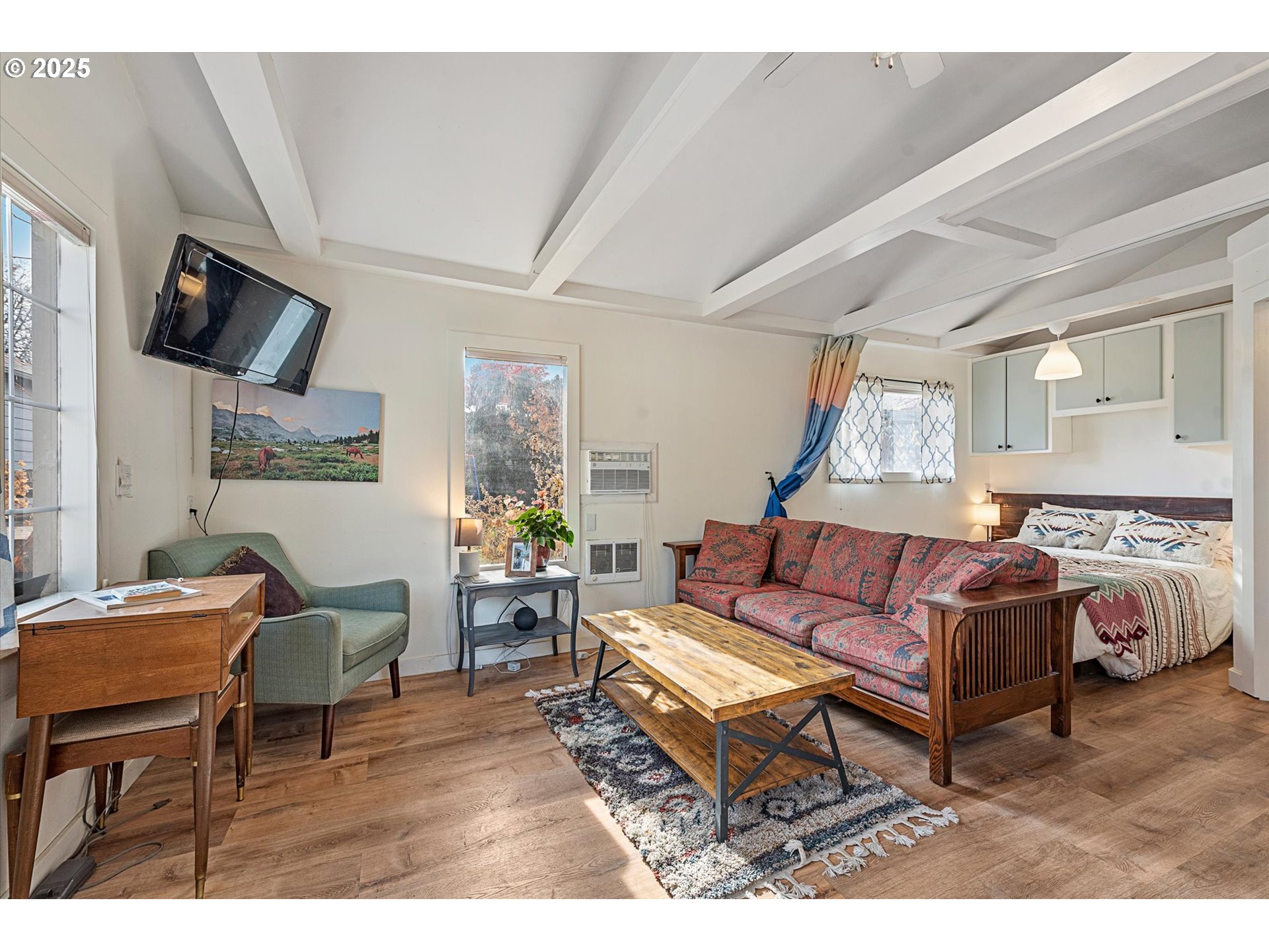 2819 College Street Baker City, OR 97814 - Photo 35 of 47 a living room with furniture a flat screen tv and kitchen view