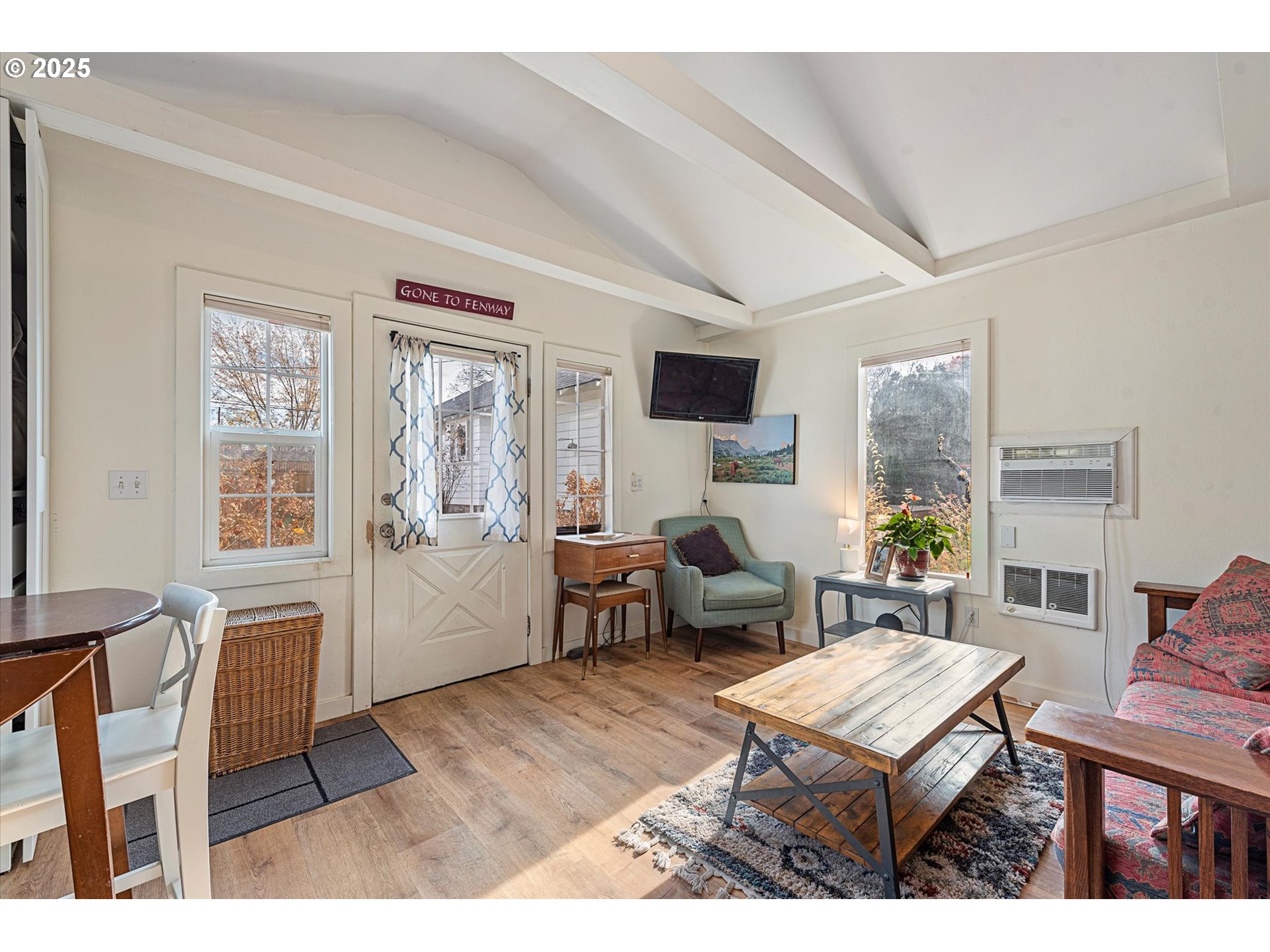2819 College Street Baker City, OR 97814 - Photo 36 of 47 a living room with furniture a dining table and a window with wooden floor