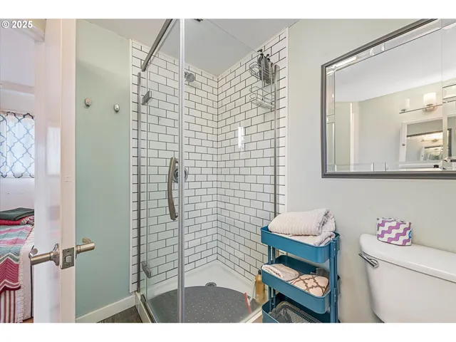 a bathroom with a toilet and a shower