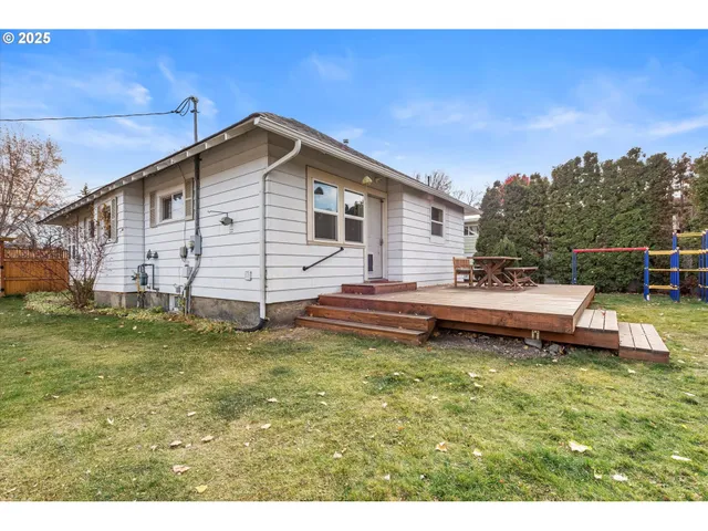 a view of a house with a yard and sitting area