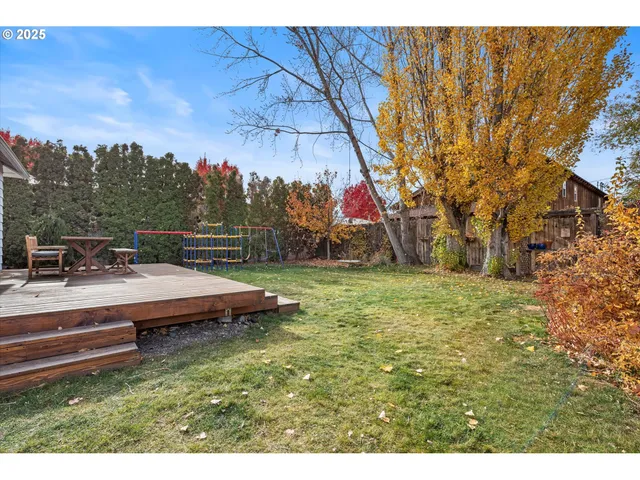 a backyard of a house with table and chairs