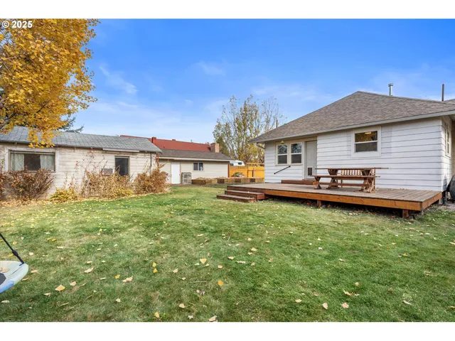a view of a house with pool and a yard