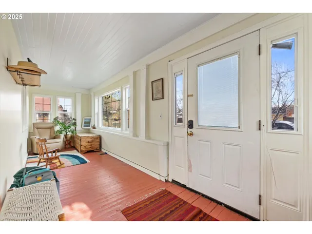 a living room with furniture window and wooden floor