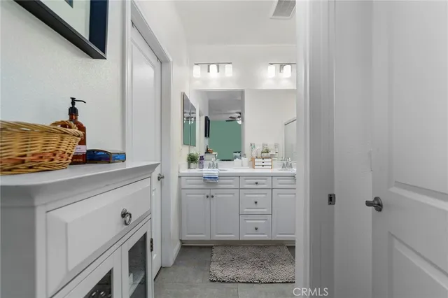 a bathroom with a sink vanity granite and a mirror