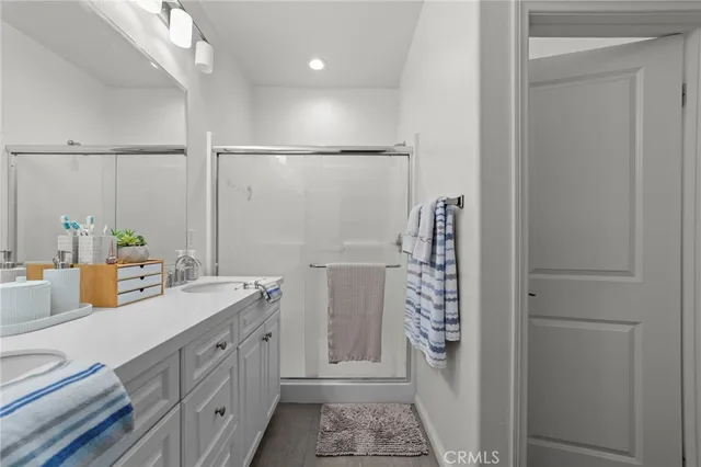a bathroom with a double vanity sink and mirror